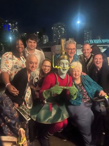 John D'Aversa as Gnip, surrounded by family and friends.