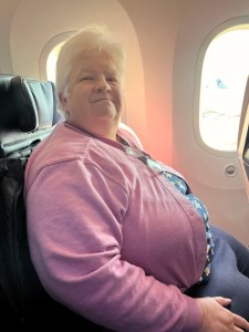 Photo of the author's wife, seated in an airplane.