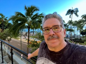 The author standing poolside with an admirable view of Waikiki Beach.